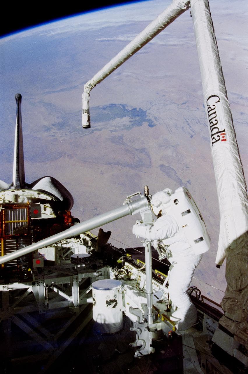 An astronaut on a spacewalk with Earth in the background — the kind of image that defines space cinema