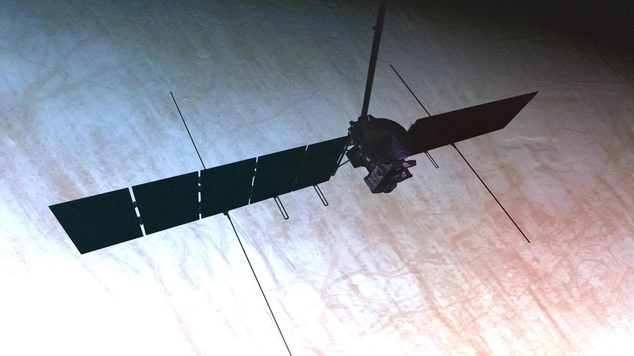 Artist's concept of Europa Clipper flying past Jupiter with Europa visible