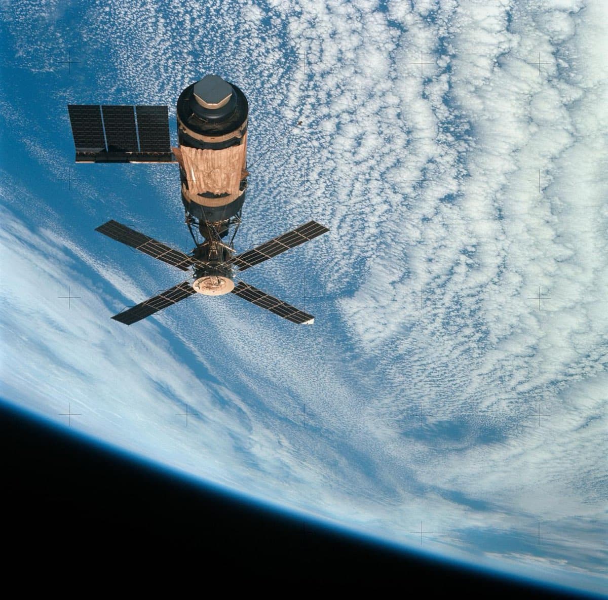 Skylab viewed from the Command/Service Module showing the parasol sunshade and solar panels
