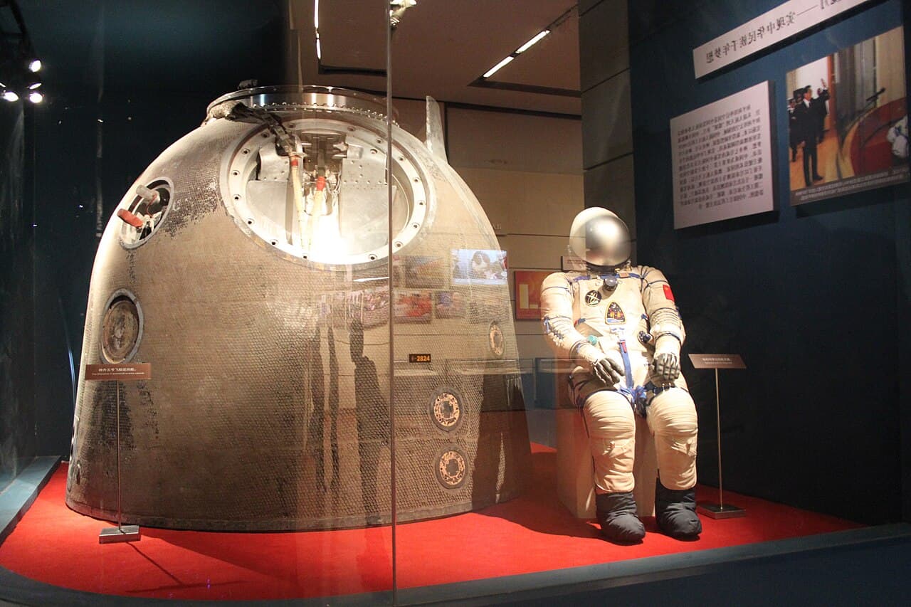 The Shenzhou V re-entry vehicle and spacesuit used by Yang Liwei on display at a Chinese museum