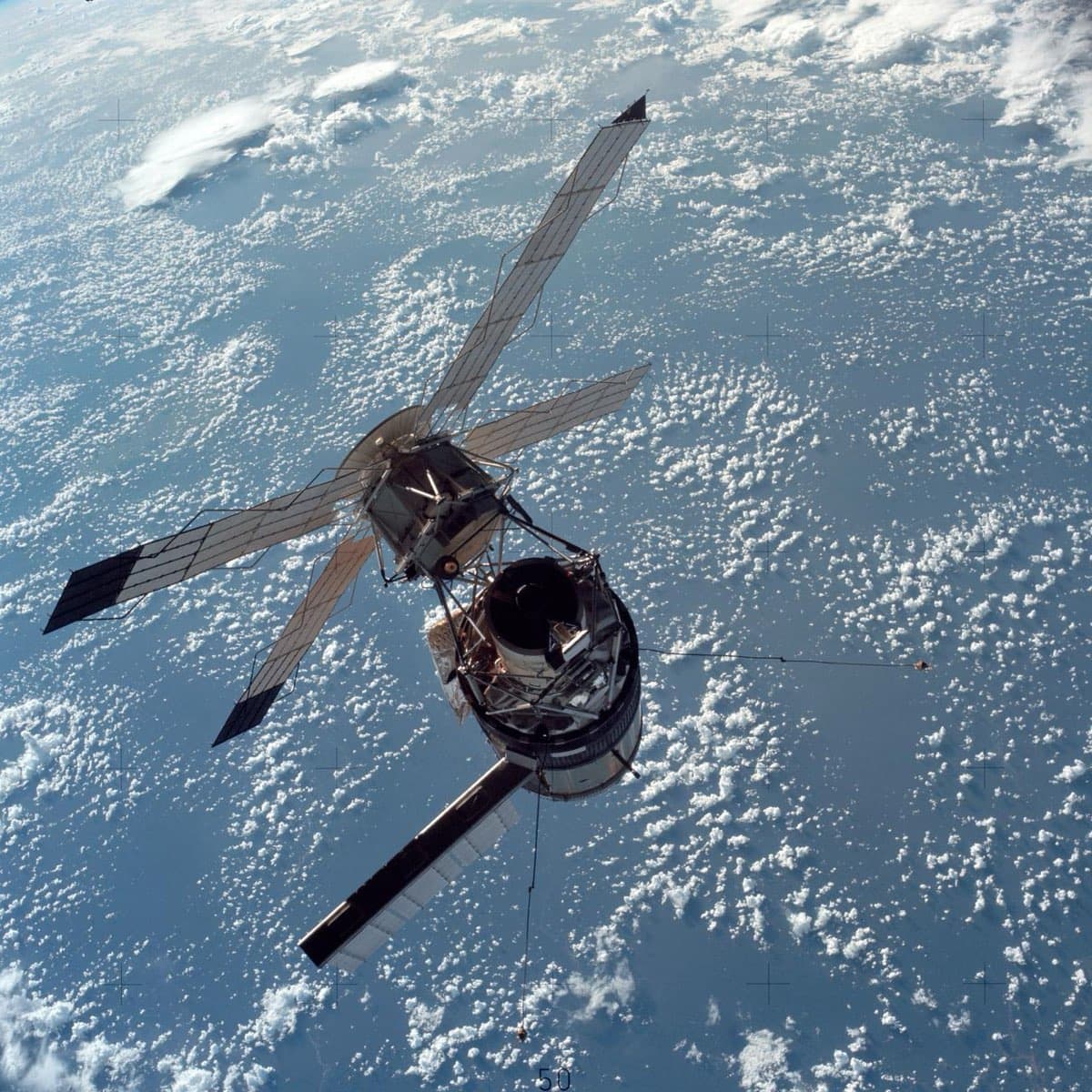 Skylab space station photographed against the black of space from the departing Apollo Command Module