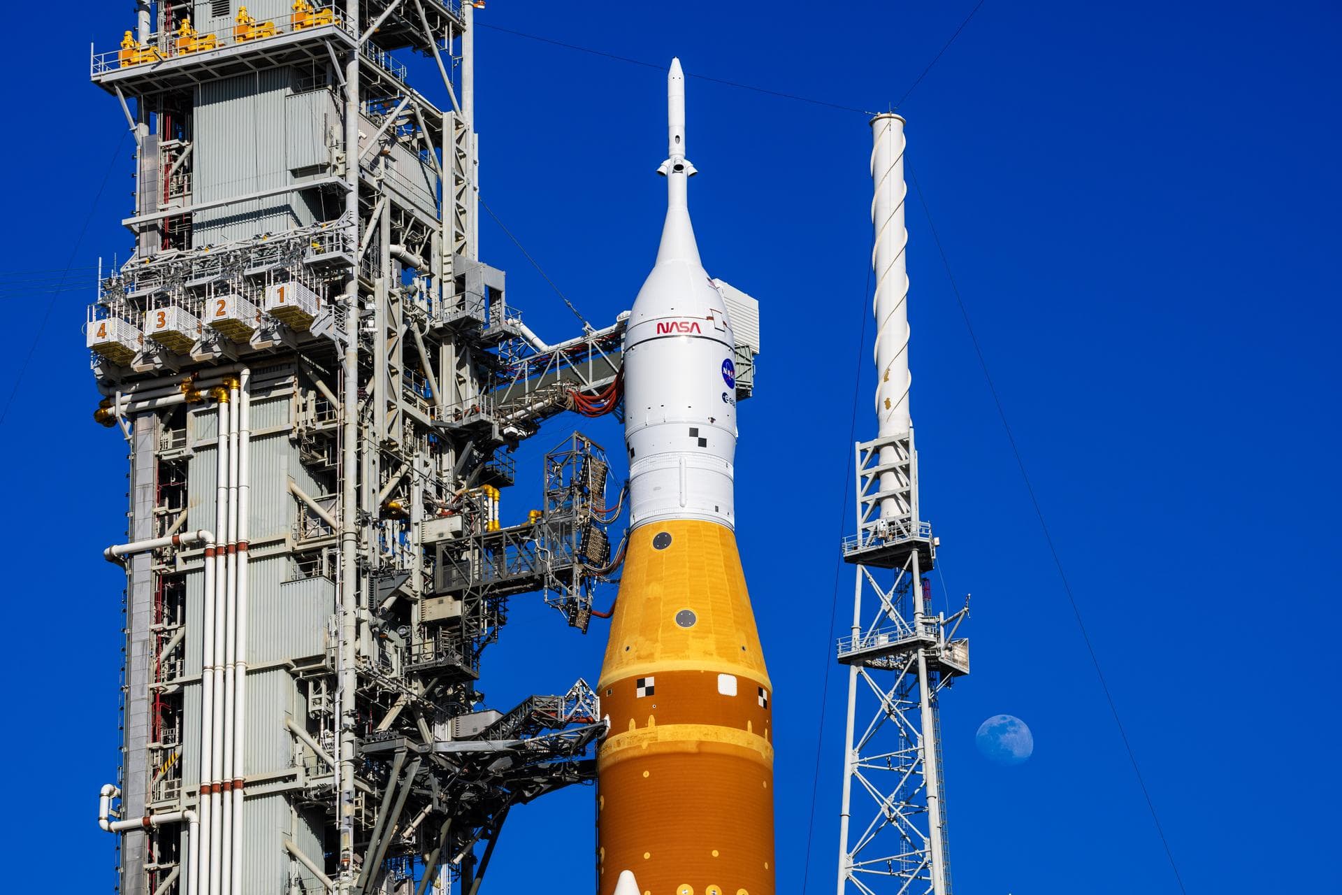 NASA Artemis II SLS rocket on Launch Pad 39B with Moon visible