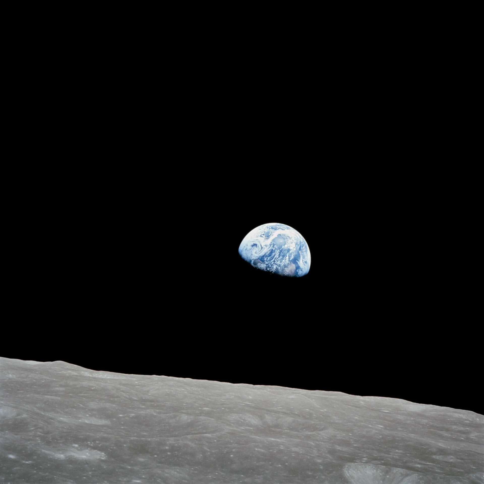 Earthrise photographed from the Apollo spacecraft showing Earth above the lunar horizon