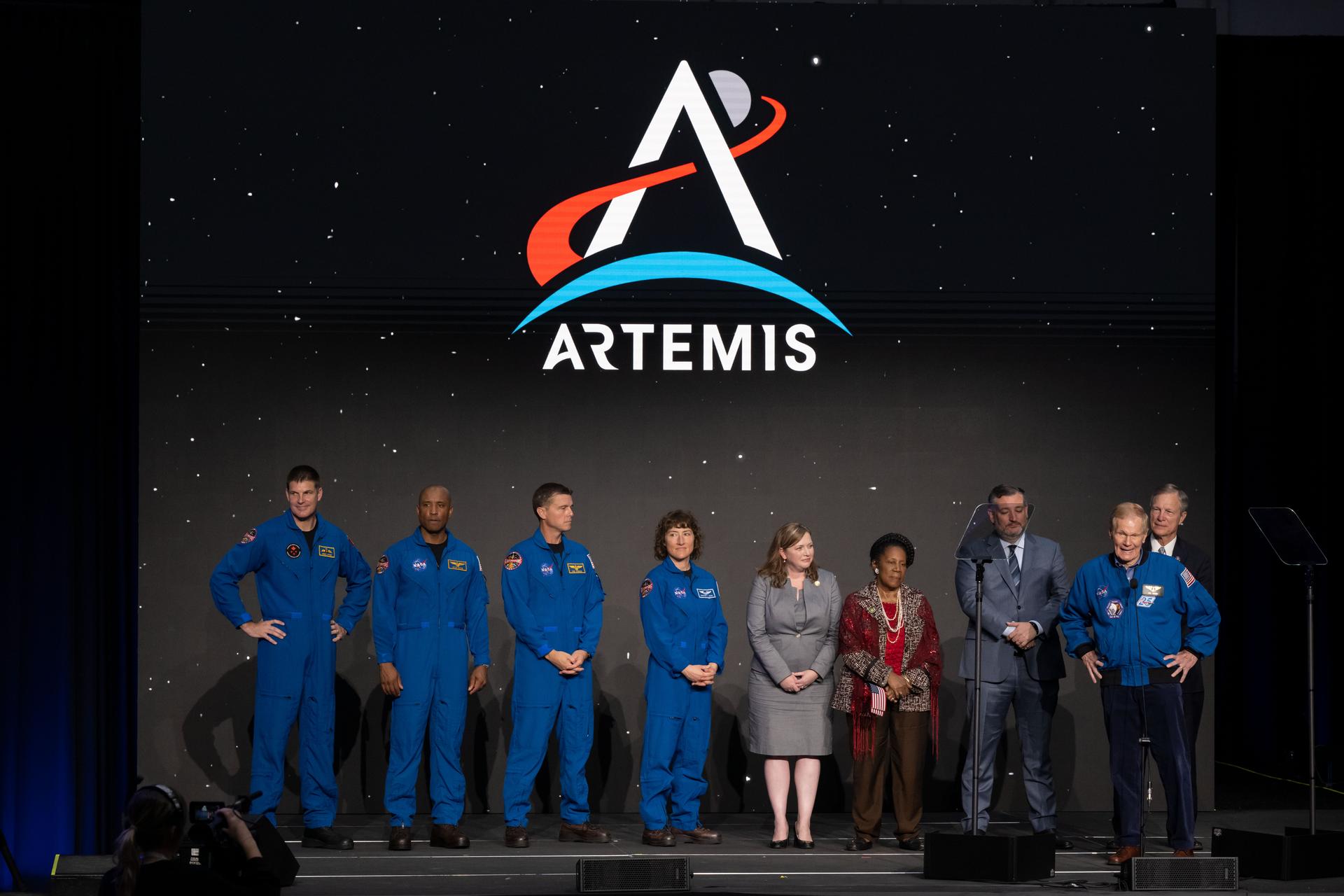The four Artemis II crew members in their orange Orion flight suits β Reid Wiseman, Victor Glover, Christina Koch, and Jeremy Hansen
