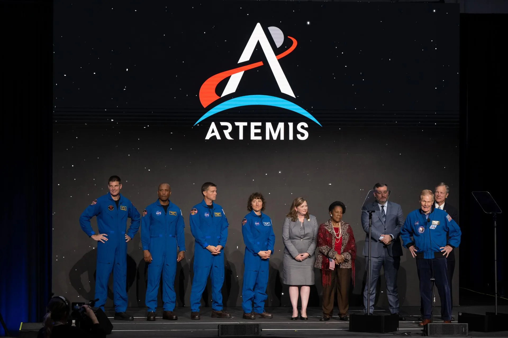 NASA's four Artemis II crew members in orange Orion pressure suits