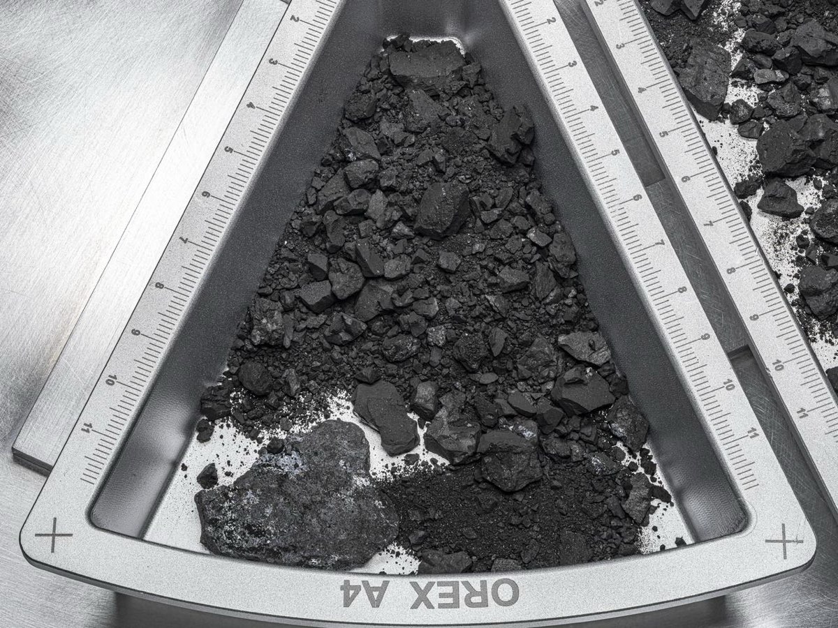 Scientists examining pristine sample material collected from asteroid Bennu