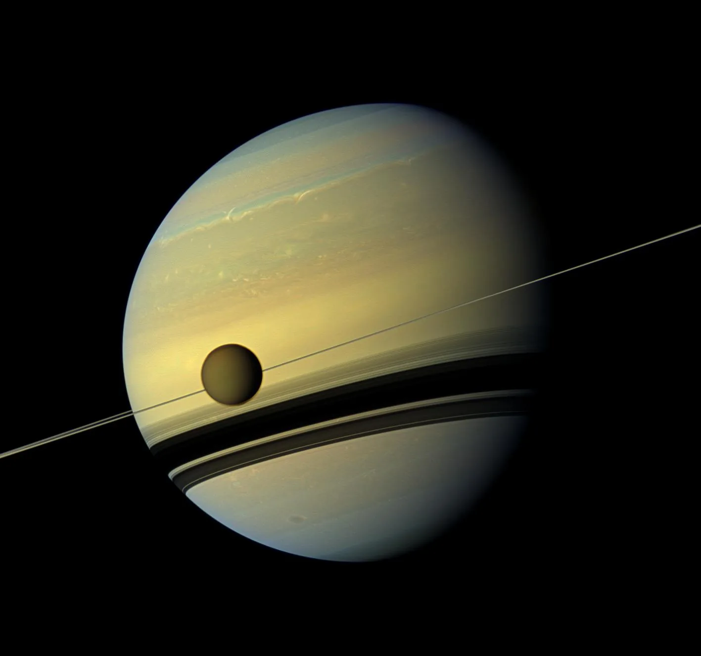 Titan's thick orange haze — another of Saturn's moons with potential for life, studied alongside Enceladus