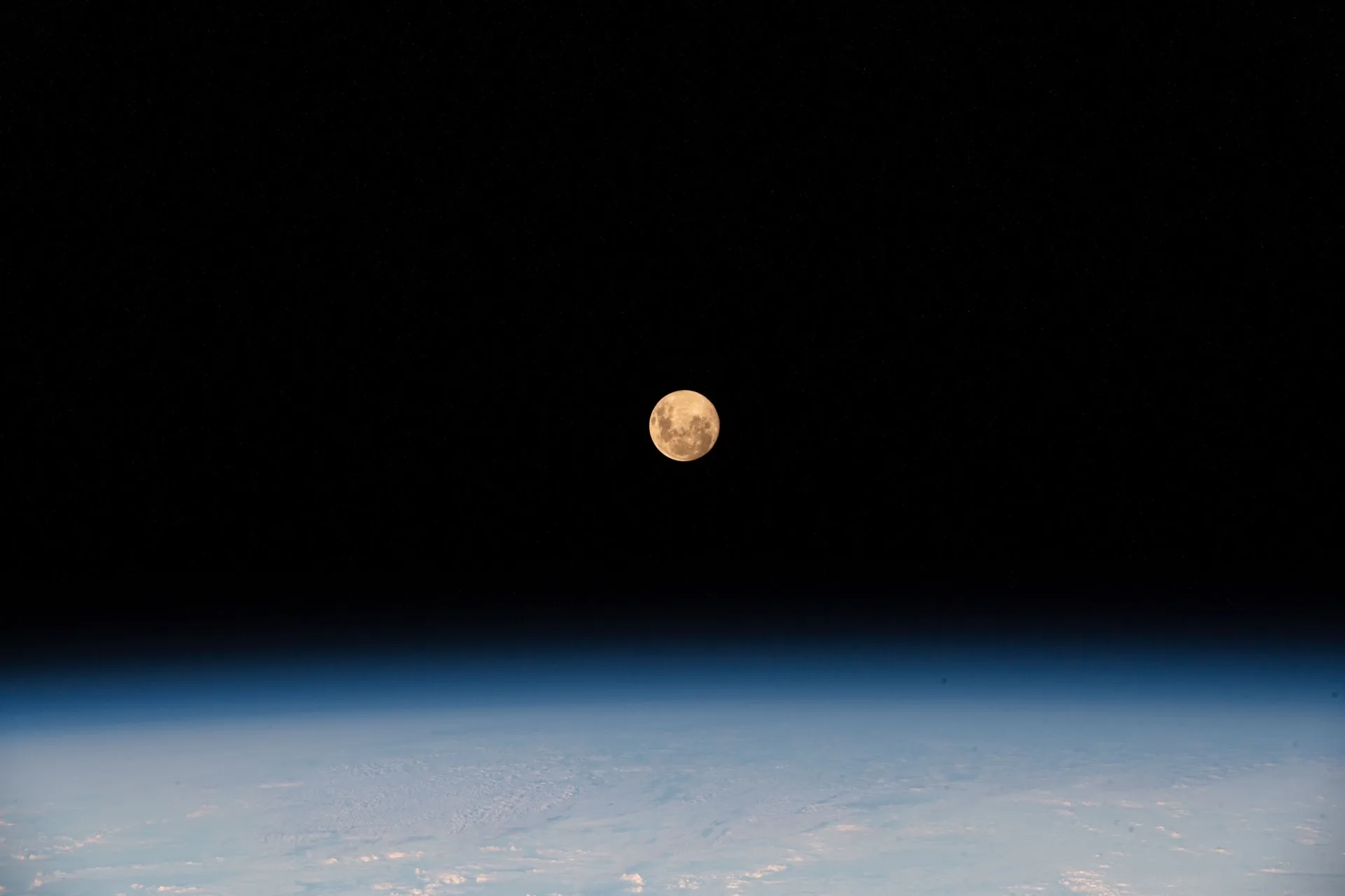 The Moon rising above Earth's atmosphere, photographed from the ISS by Thomas Pesquet