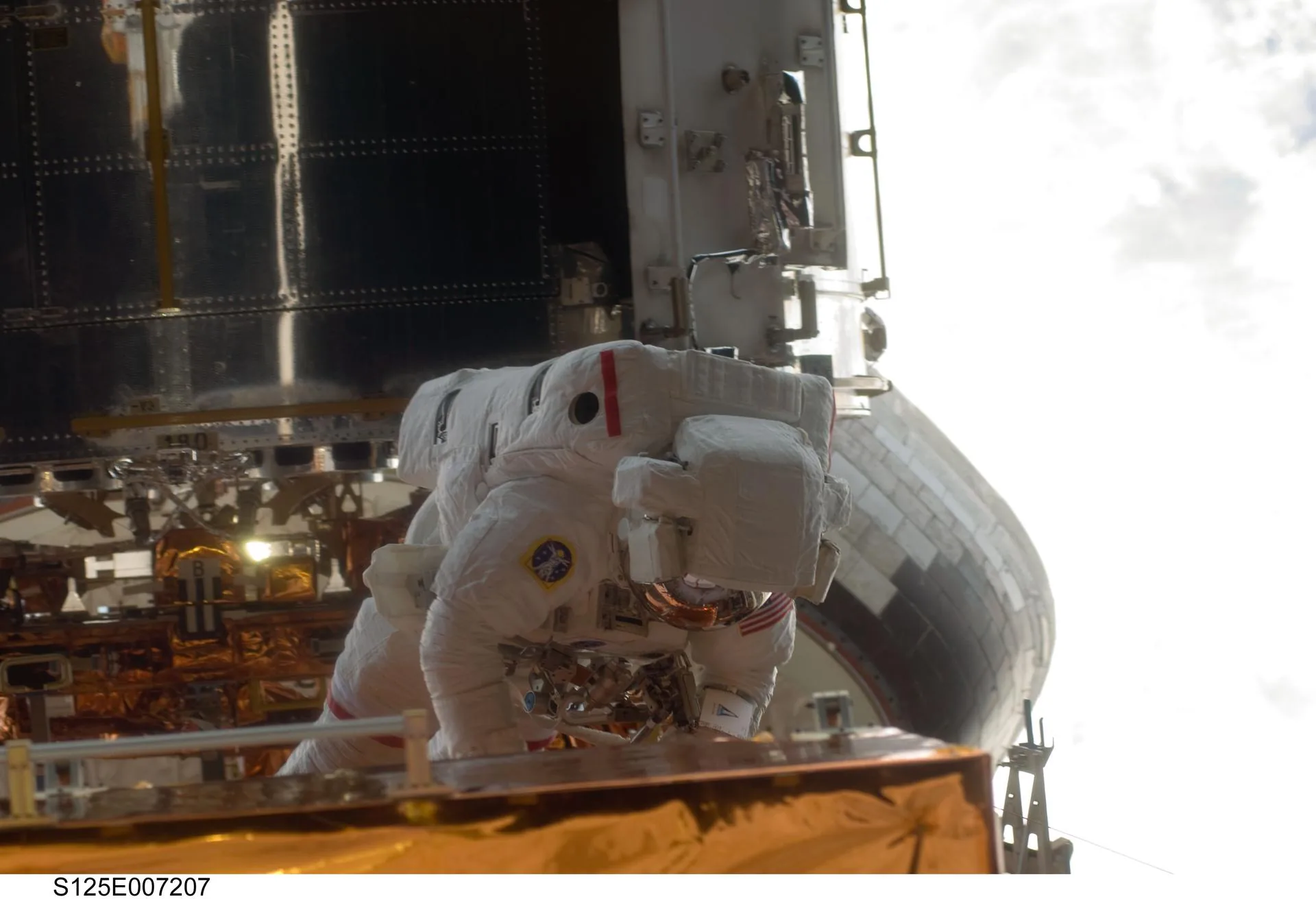 Astronauts performing repairs on the Hubble Space Telescope during a servicing mission