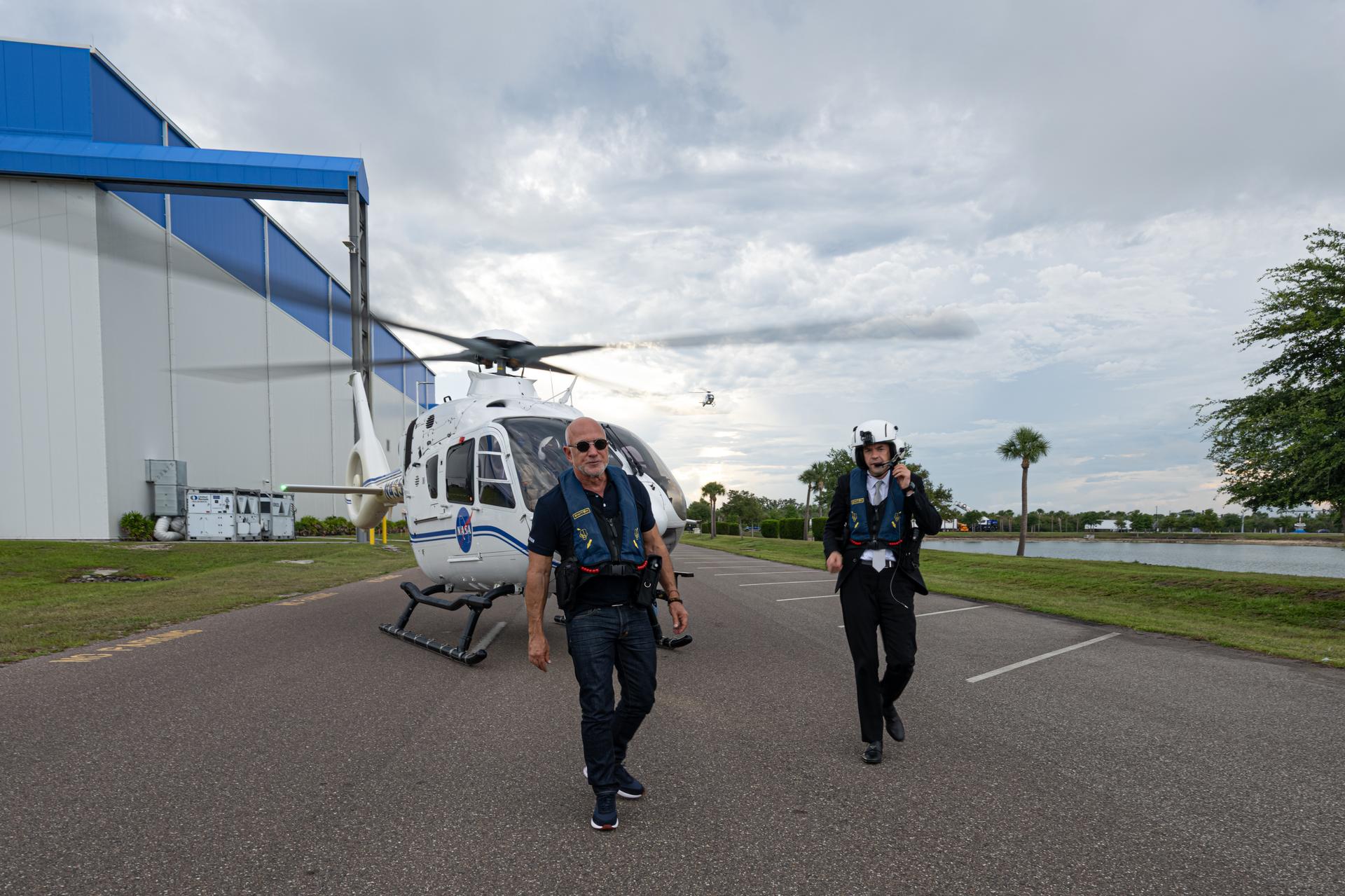 NASA Administrator Jared Isaacman and Jeff Bezos step off a NASA helicopter after a flyover of the destroyed Launch Complex 36 site on May 29, 2026