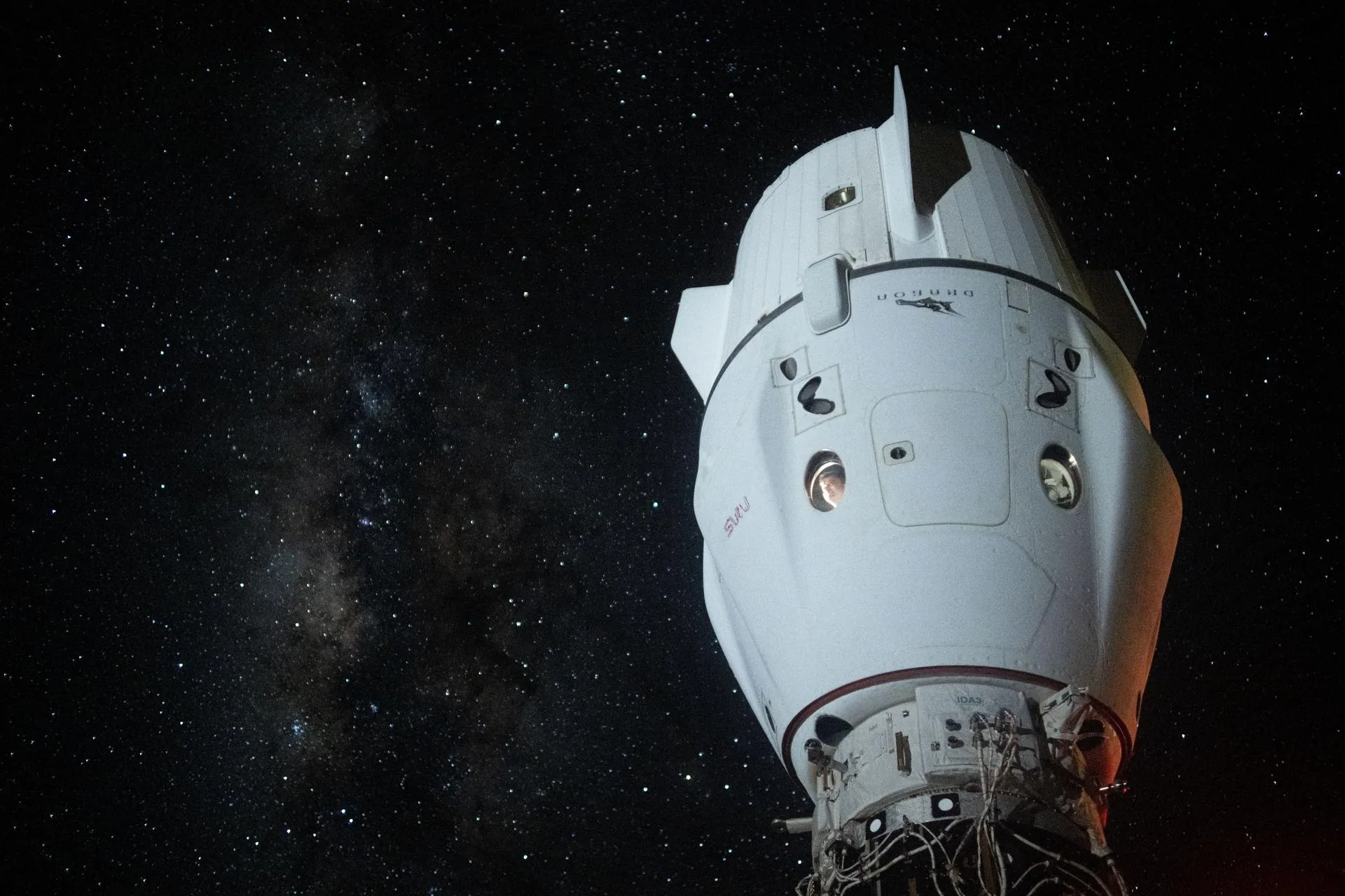 SpaceX Crew Dragon Endeavour docked at the International Space Station with the Milky Way visible in the background