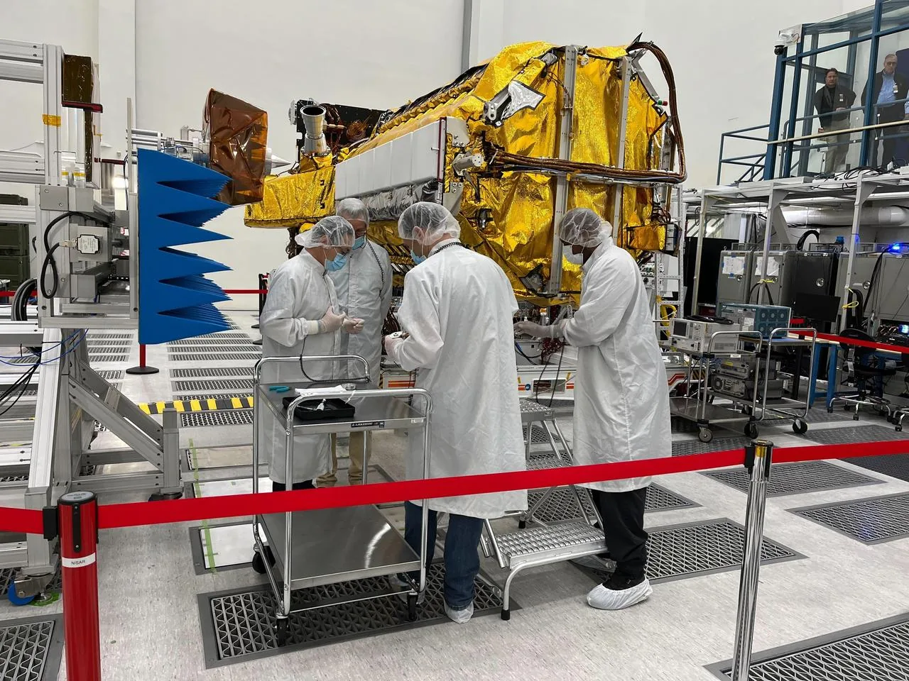 Engineers in clean-room attire integrating the NISAR Earth-observation satellite — the engineering reality investors are evaluating when scoring a space company