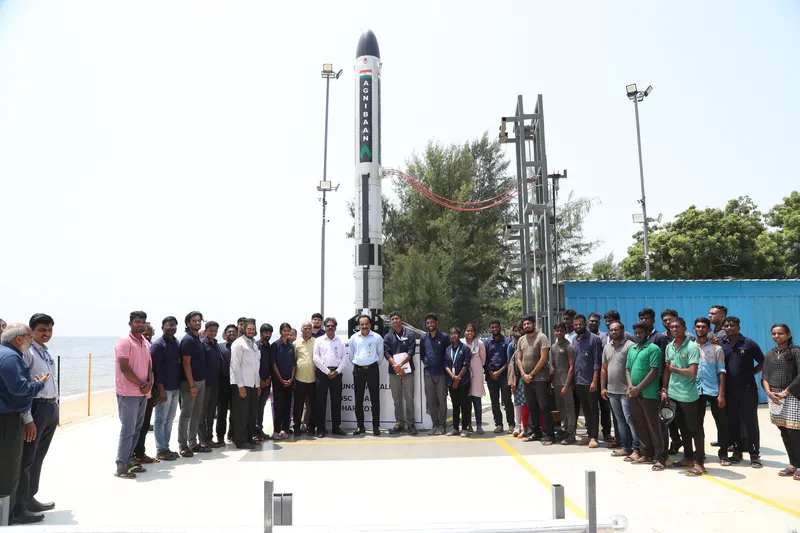 The Agnibaan SOrTeD vehicle standing on Agnikul's private 'Dhanush' launchpad at Sriharikota with the engineering team, before the 30 May 2024 flight.