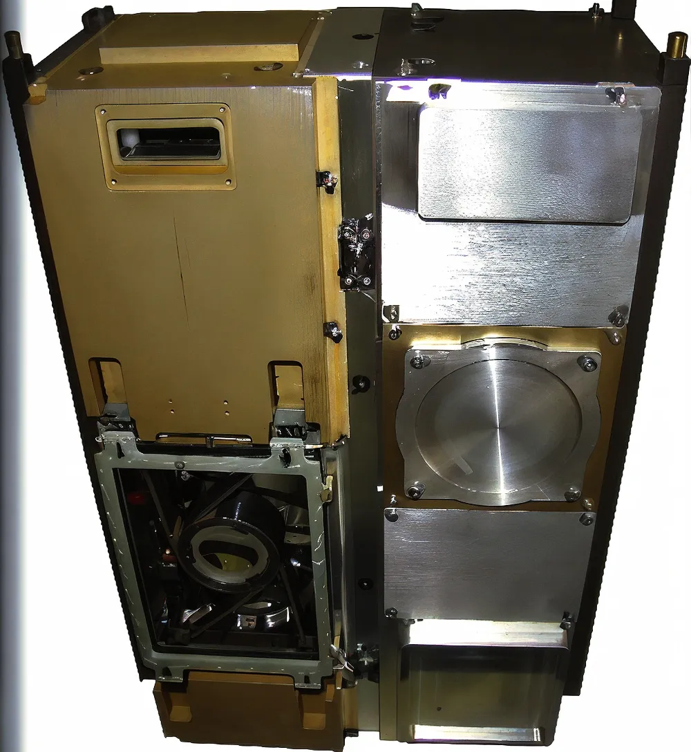 Photograph of an AKAER satellite optical-payload module with gold thermal foil and exposed telescope optics.