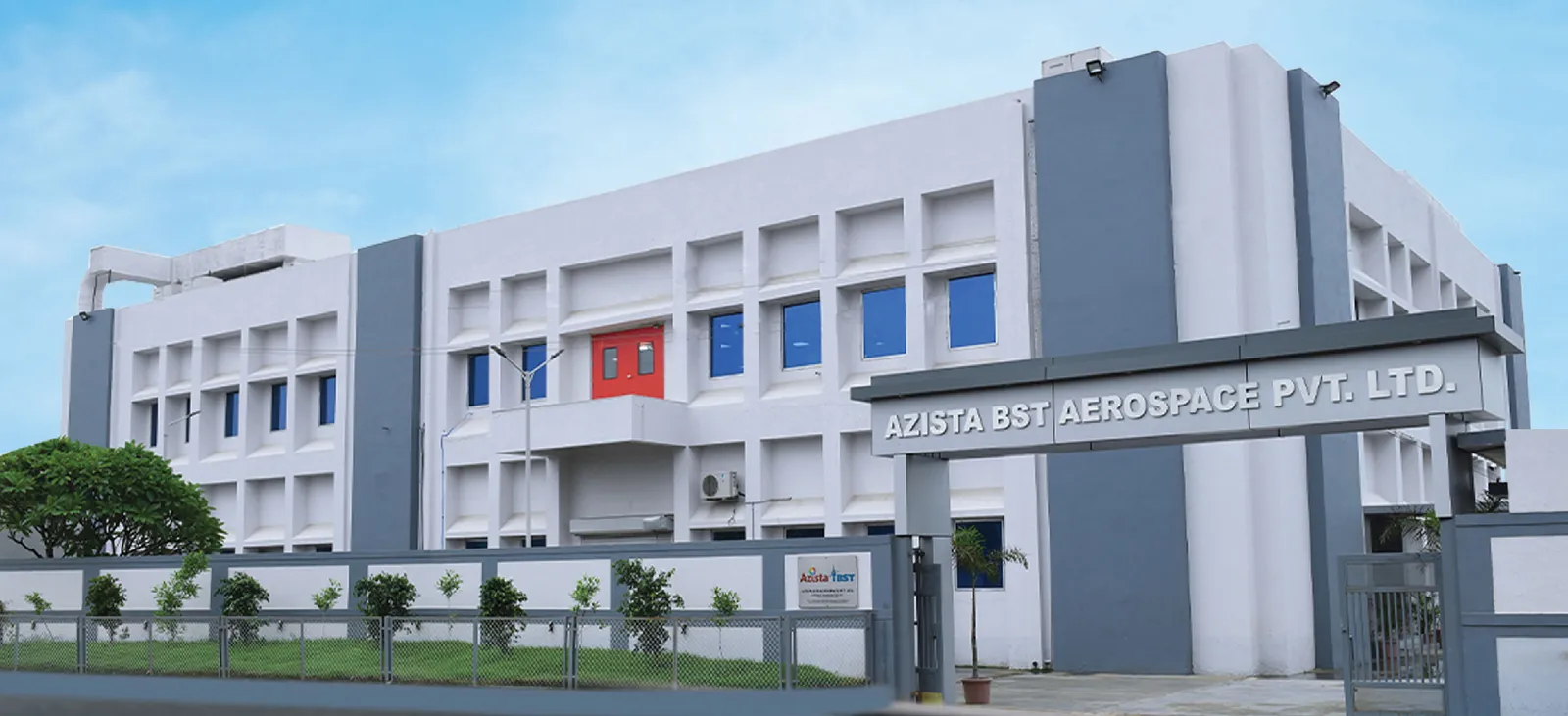 The Azista BST Aerospace facility building, with company signage — the Indo-German JV runs a high-volume small-satellite production line in Hyderabad and Ahmedabad, India.