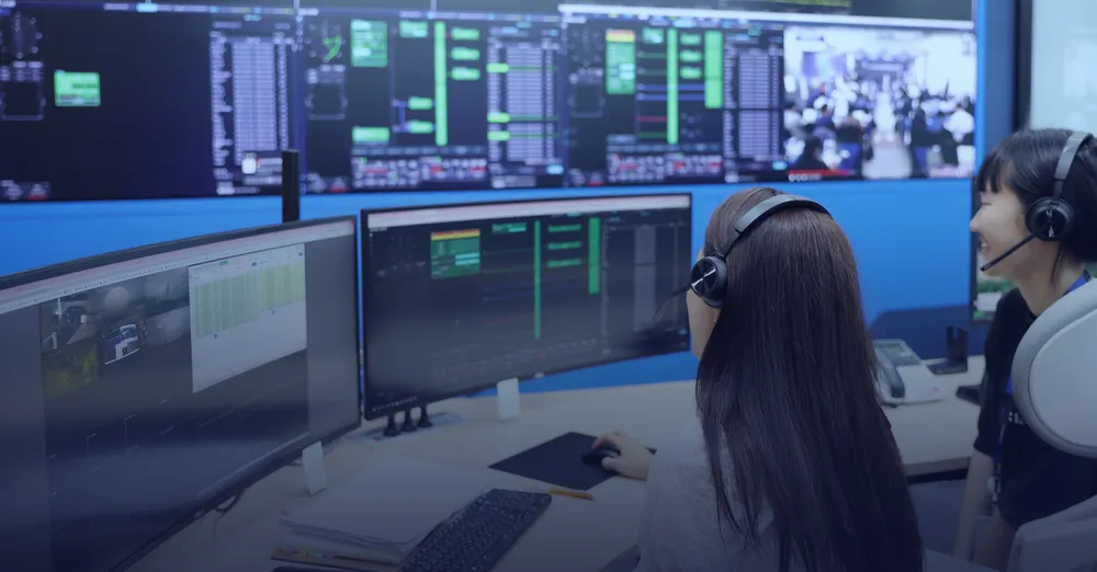 Contec operators monitoring satellite telemetry at consoles inside the company's satellite operations / mission-control centre.