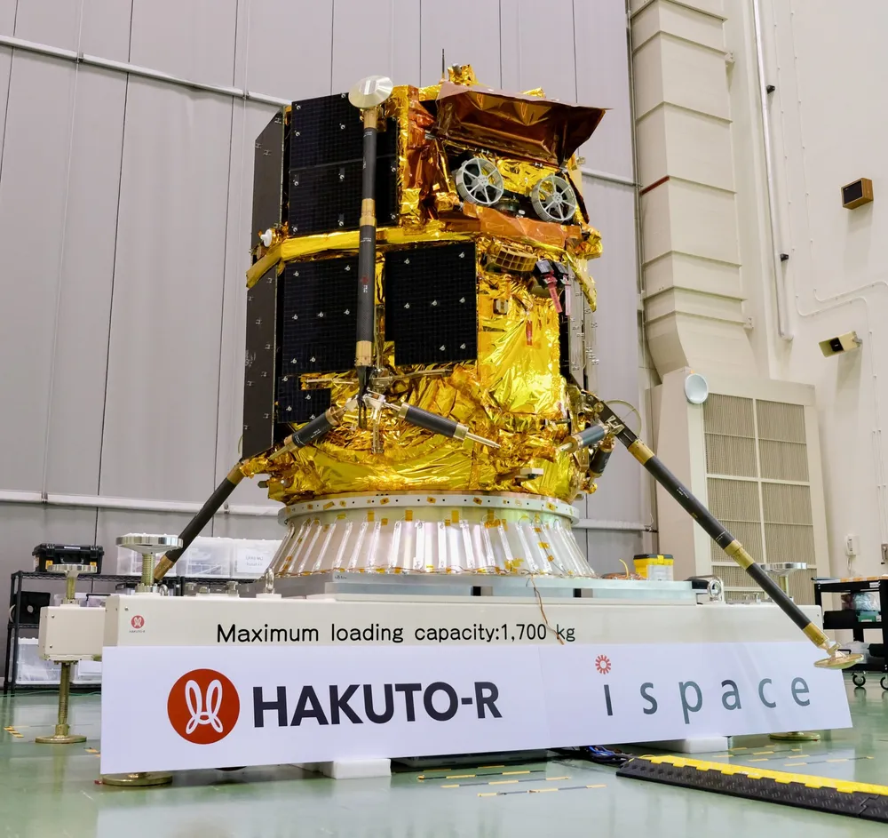 ispace's RESILIENCE lunar lander (the HAKUTO-R Mission 2 flight model) on its landing legs in a cleanroom at JAXA's Tsukuba Space Center.