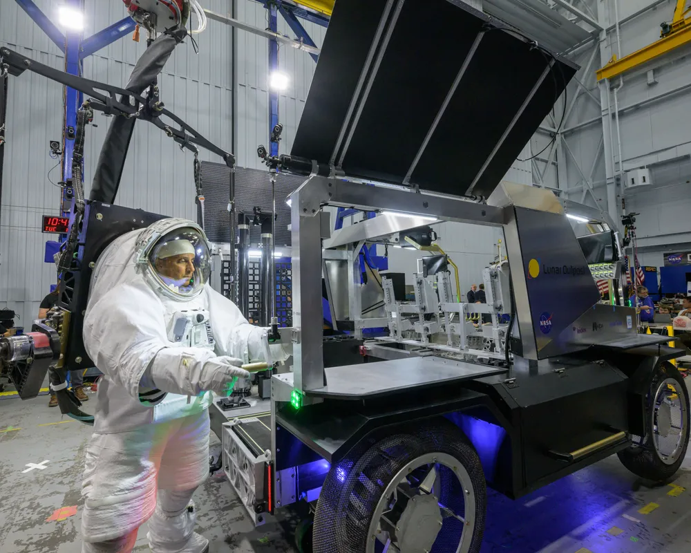 NASA astronaut Joe Acaba raises the solar array on Lunar Outpost's Eagle lunar terrain vehicle during testing at Johnson Space Center, October 2024.