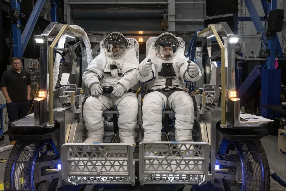Astronauts Raja Chari and Randy Bresnik evaluate the seat configuration inside Lunar Outpost's Eagle lunar terrain vehicle, October 2024.
