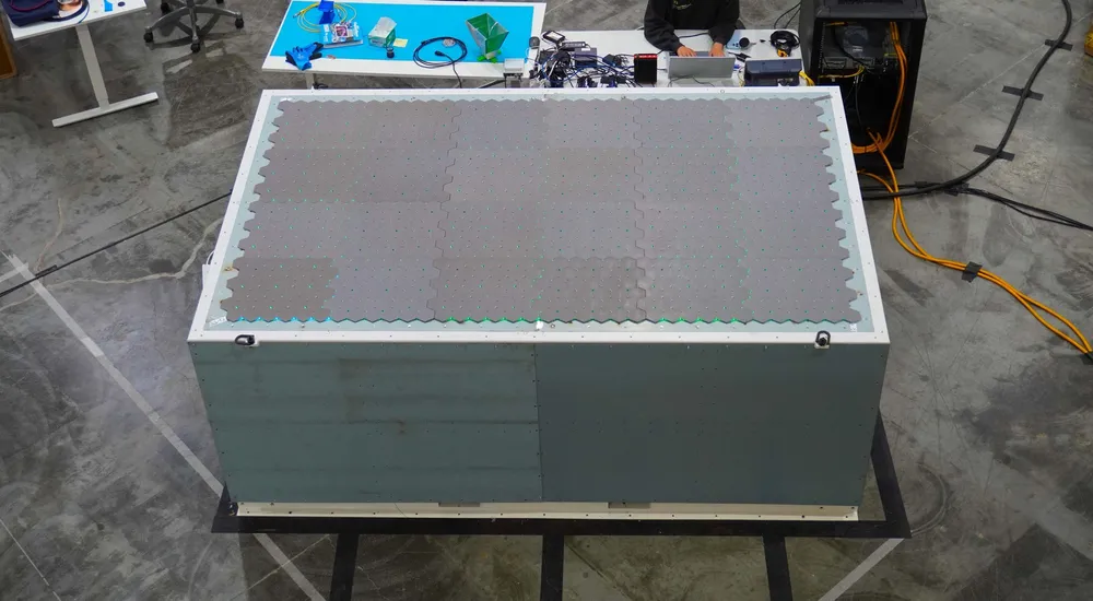 Close-up of Northwood Space's Portal flat-panel phased-array antenna face during lab testing — the hardware that replaces a large parabolic dish.
