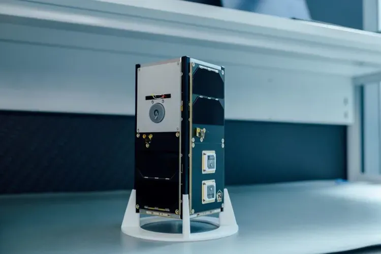 The GRBBeta 2U CubeSat on a stand in a clean lab — the successor to GRBAlpha, launched on the maiden flight of Europe's Ariane 6.
