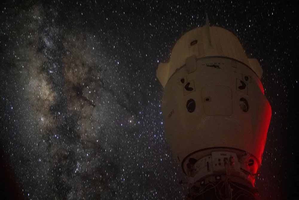 The Milky Way glows behind a SpaceX Dragon Endeavour docked to the ISS.