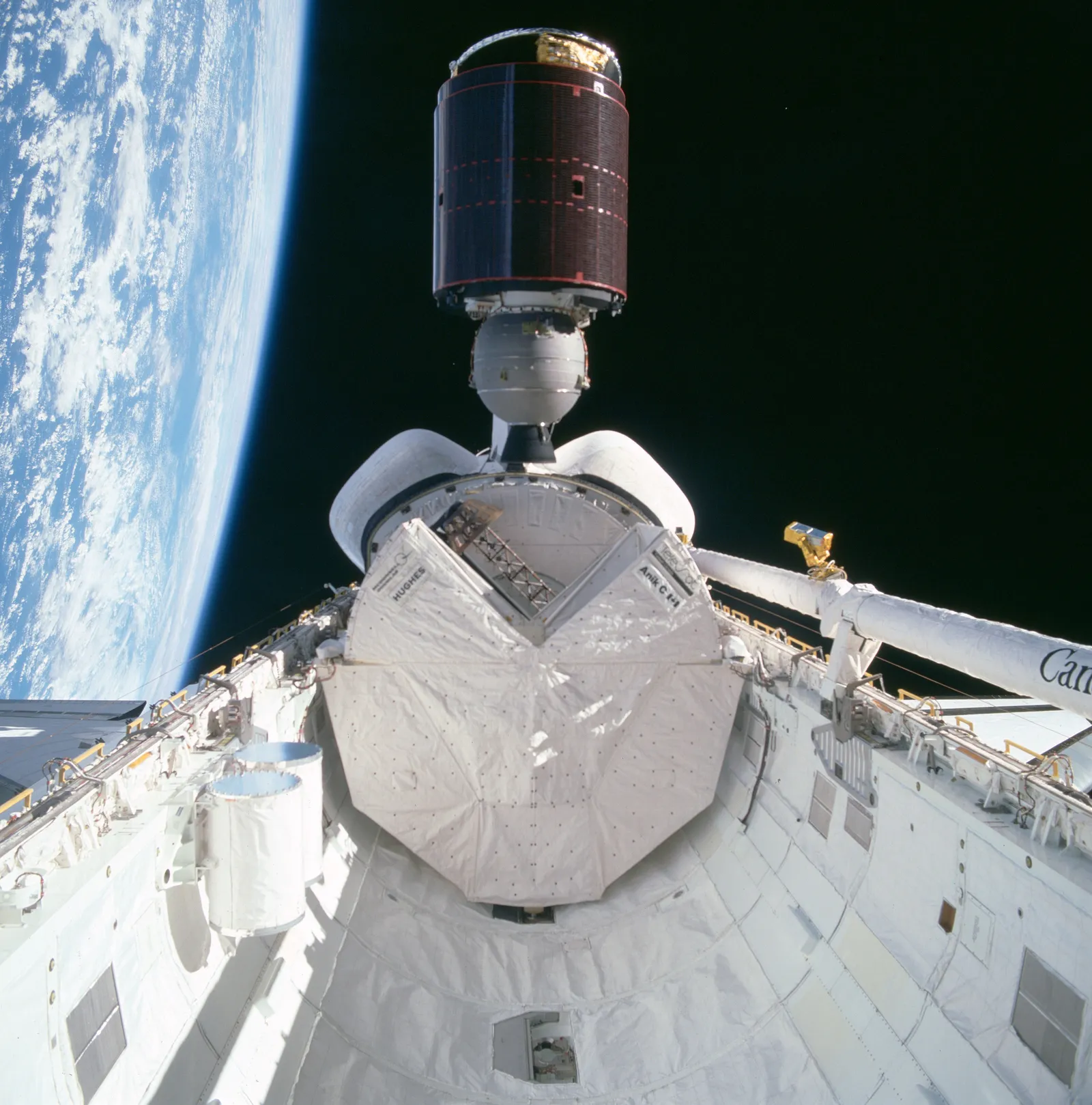 Telesat's Anik C-1 communications satellite deploys from the Space Shuttle Discovery's payload bay above Earth during mission STS-51-D, April 1985.