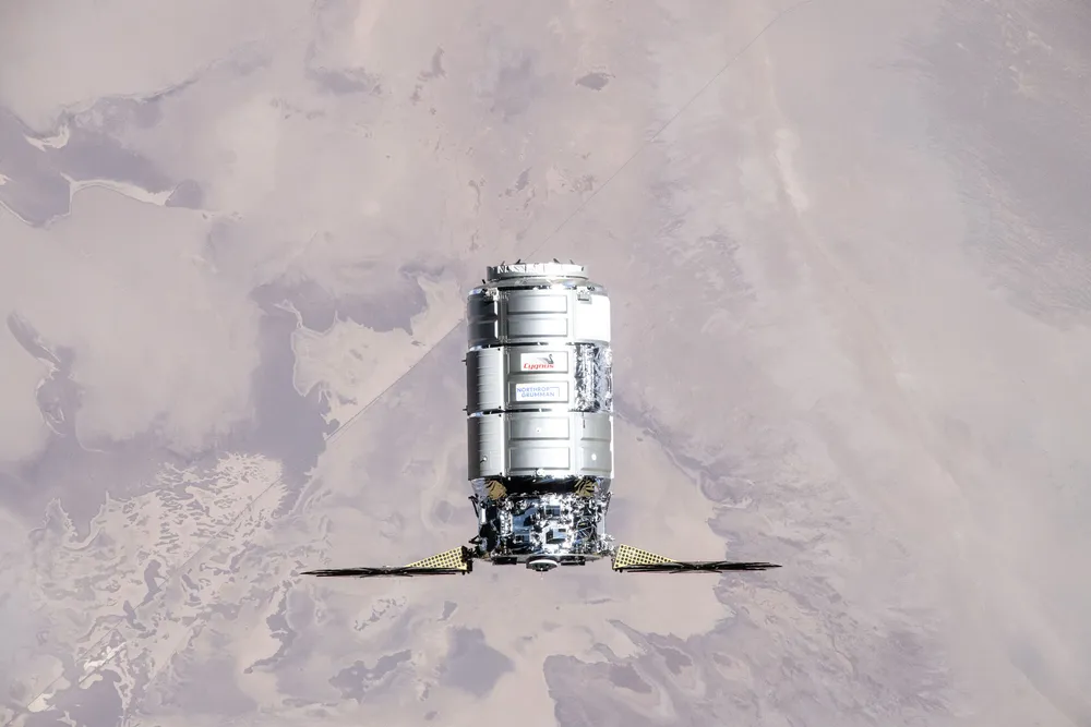 A Northrop Grumman Cygnus cargo spacecraft approaches the ISS; its Pressurized Cargo Module is built by Thales Alenia Space.