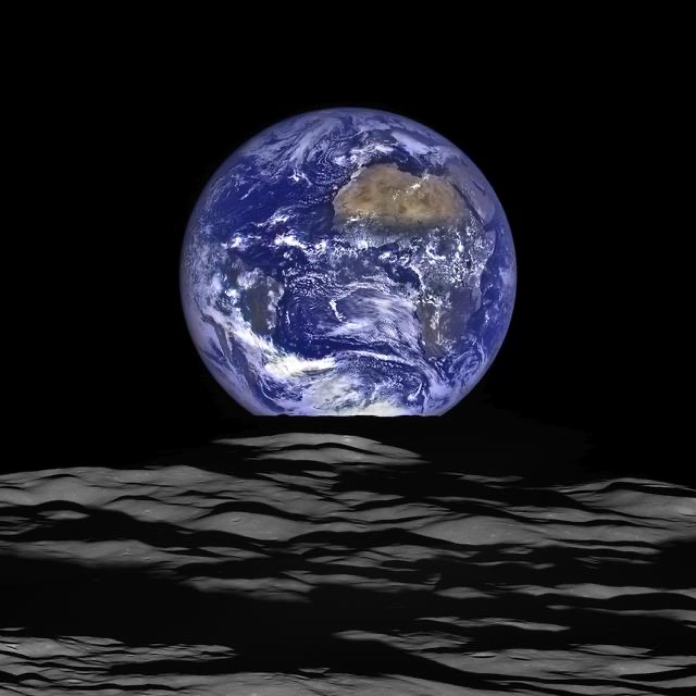 Earth rising above the Moon's cratered grey horizon, blue and white against black space.