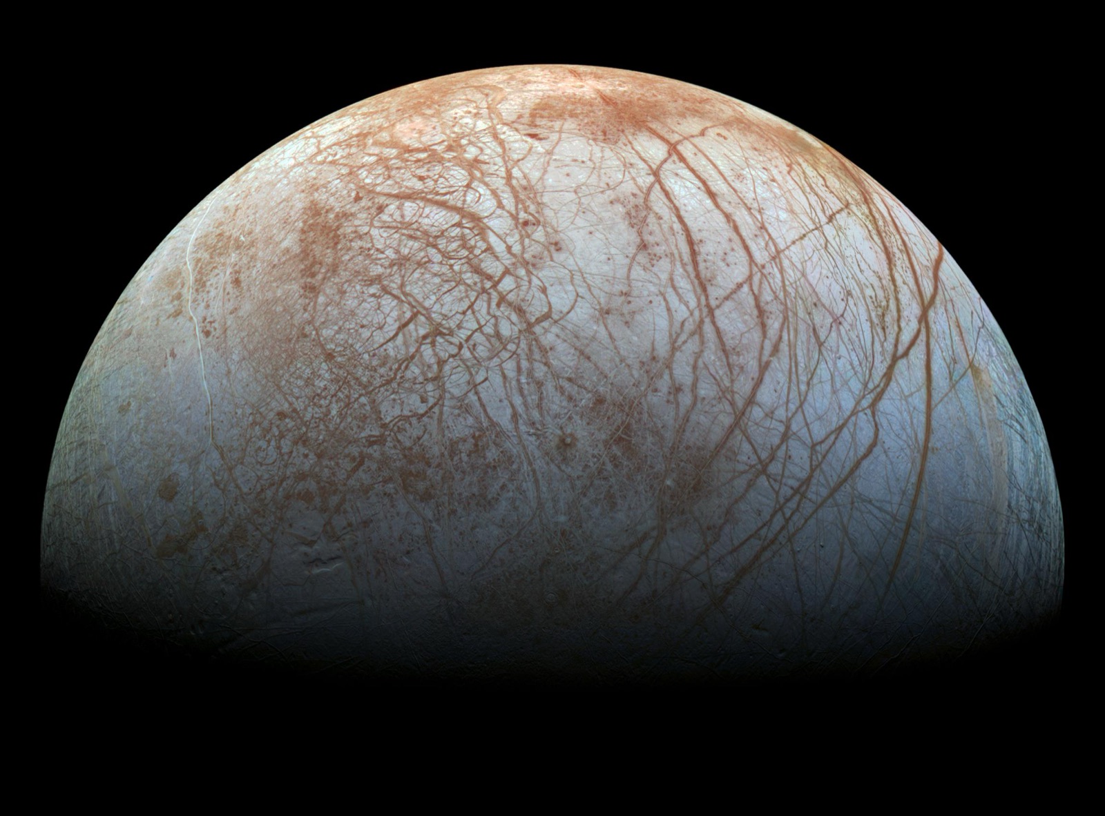 Europa's cracked ice shell, laced with reddish linear fractures, imaged by Galileo.