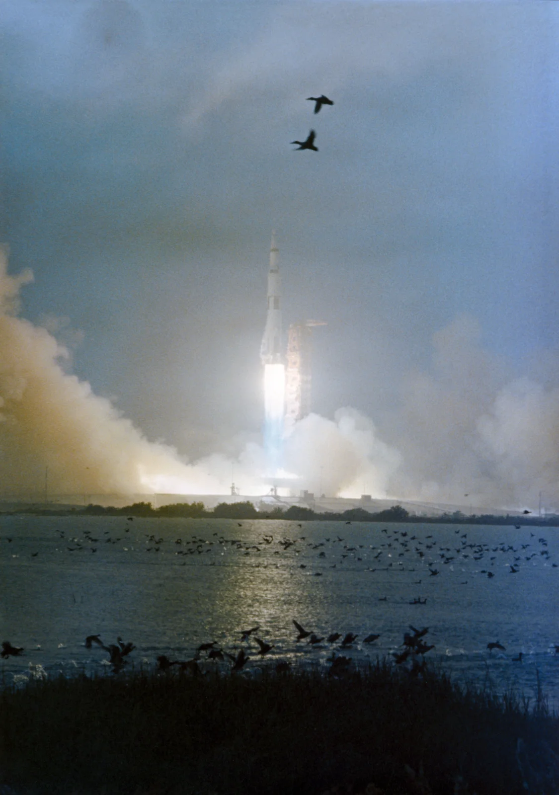 Apollo 12's Saturn V climbs into a rainy, overcast sky from Kennedy Space Center, November 14, 1969