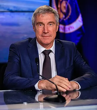 Sergei Krikalev in his Roscosmos flight suit, veteran of six spaceflights.