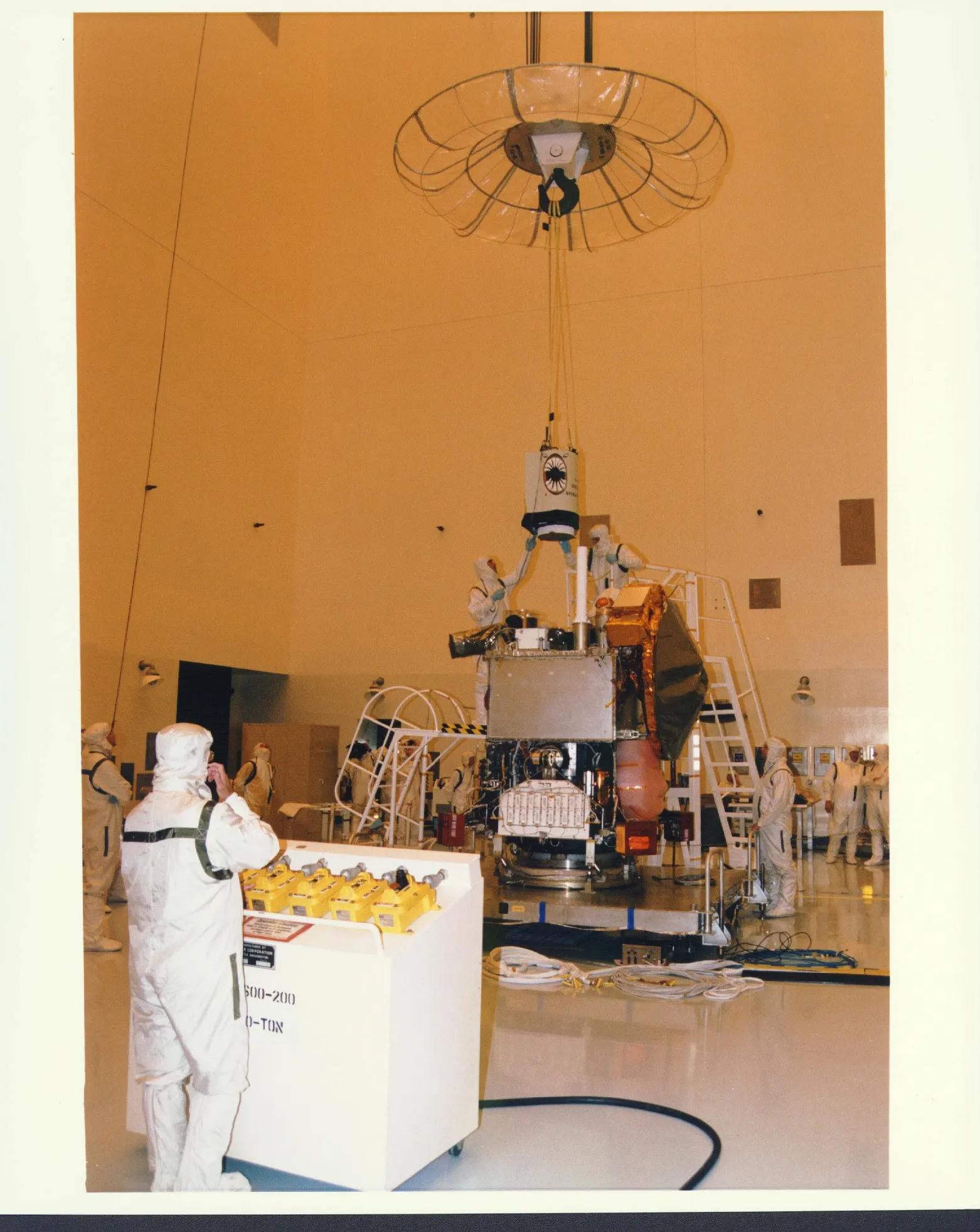 Mars Global Surveyor being lowered onto its workstand during assembly at Kennedy Space Center, 1996