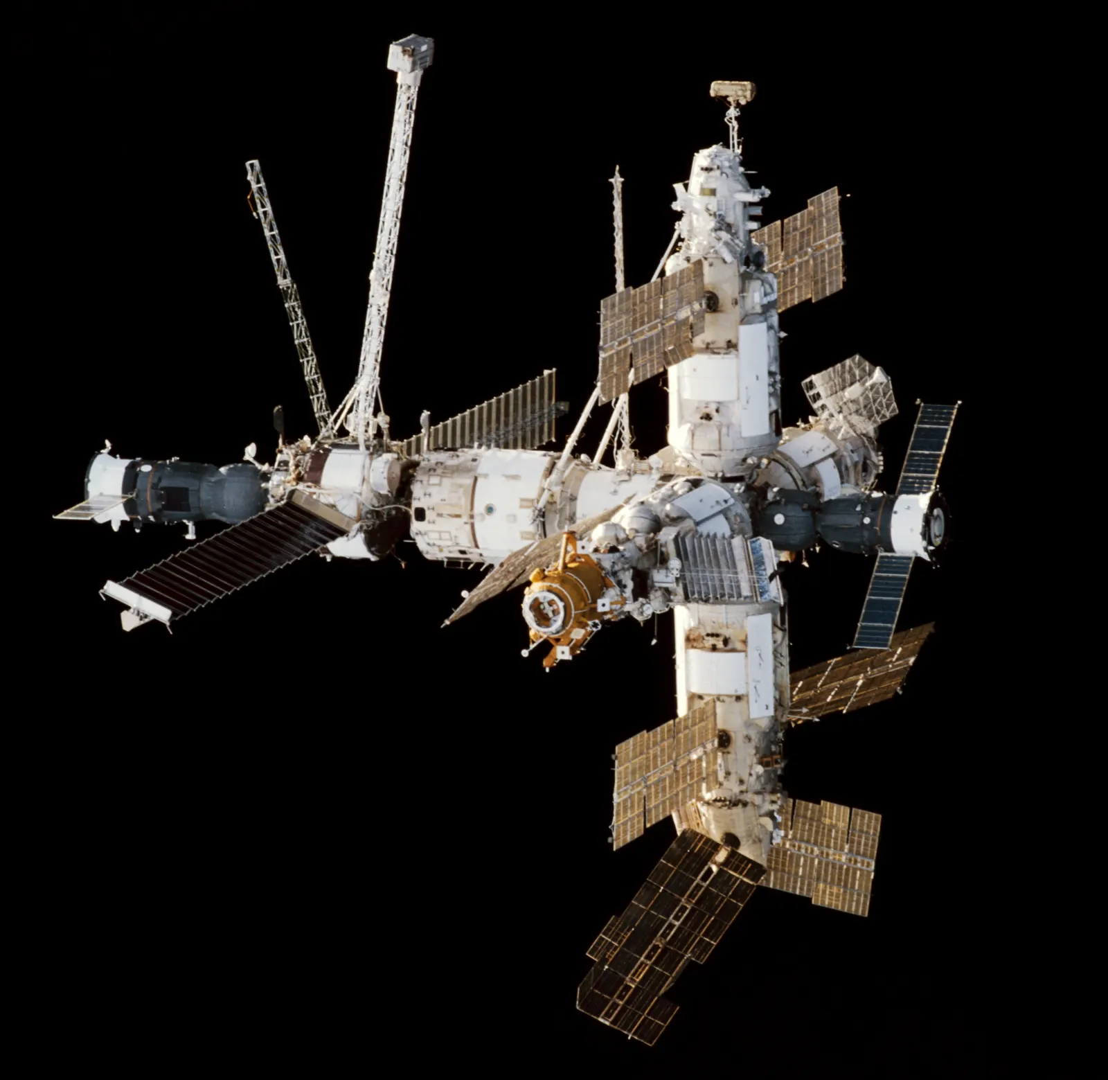 The Mir space station photographed in orbit with a Soyuz spacecraft and Progress cargo ship docked