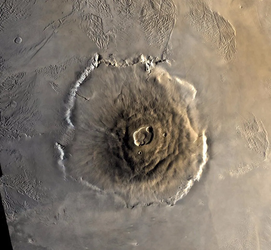 Color mosaic of Olympus Mons, the largest volcano in the solar system, with its summit caldera