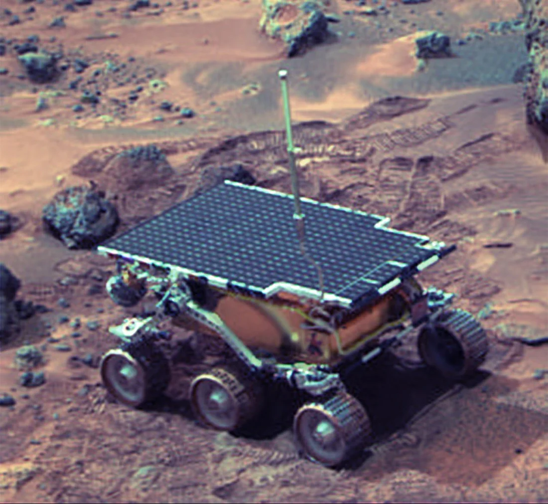 NASA's Sojourner rover, solar panel and six wheels visible, on the rocky Martian surface at Ares Vallis, July 1997