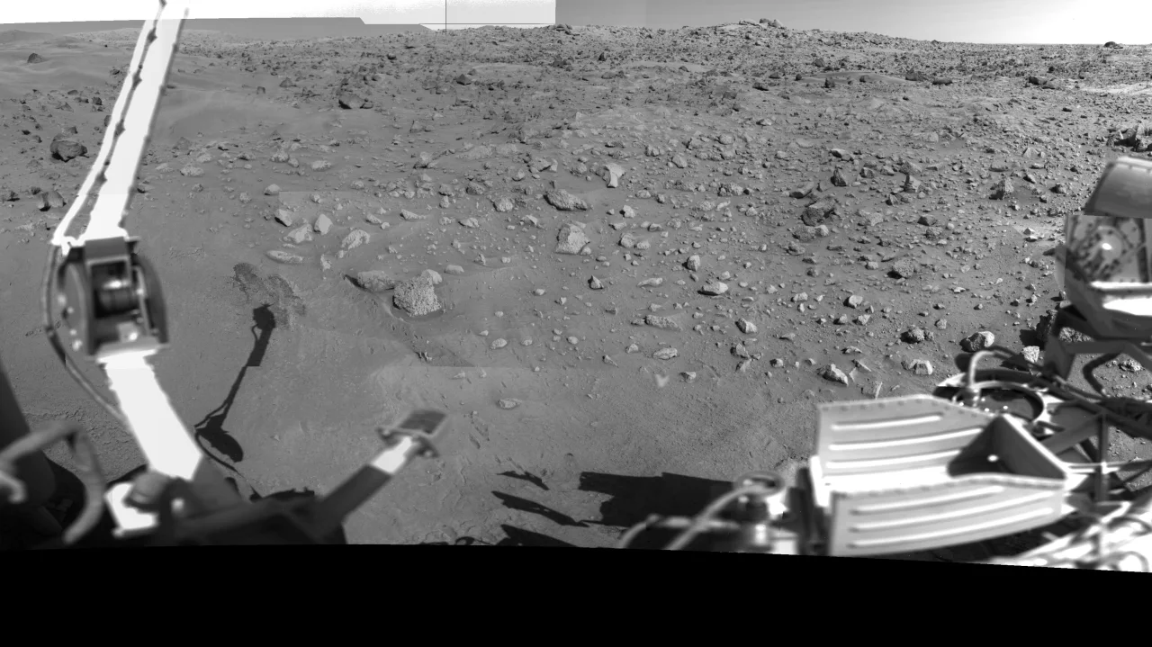 Viking Lander 1's surface panorama on Chryse Planitia, Mars — the lander's sampling arm and instrument deck framing the rock-strewn terrain, 1976