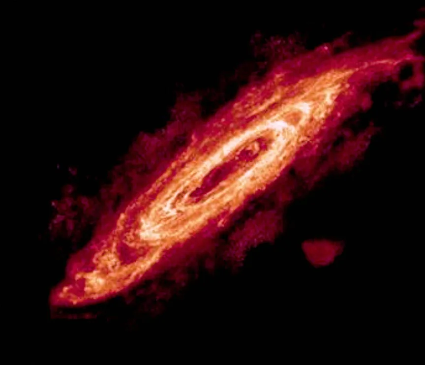 Andromeda Galaxy in radio — WSRT H I 21-cm mapping reveals the cold neutral hydrogen disc of M31, extending to ~40 kpc radius and showing a prominent warp — likely due to tidal interactions with M32 and M110.