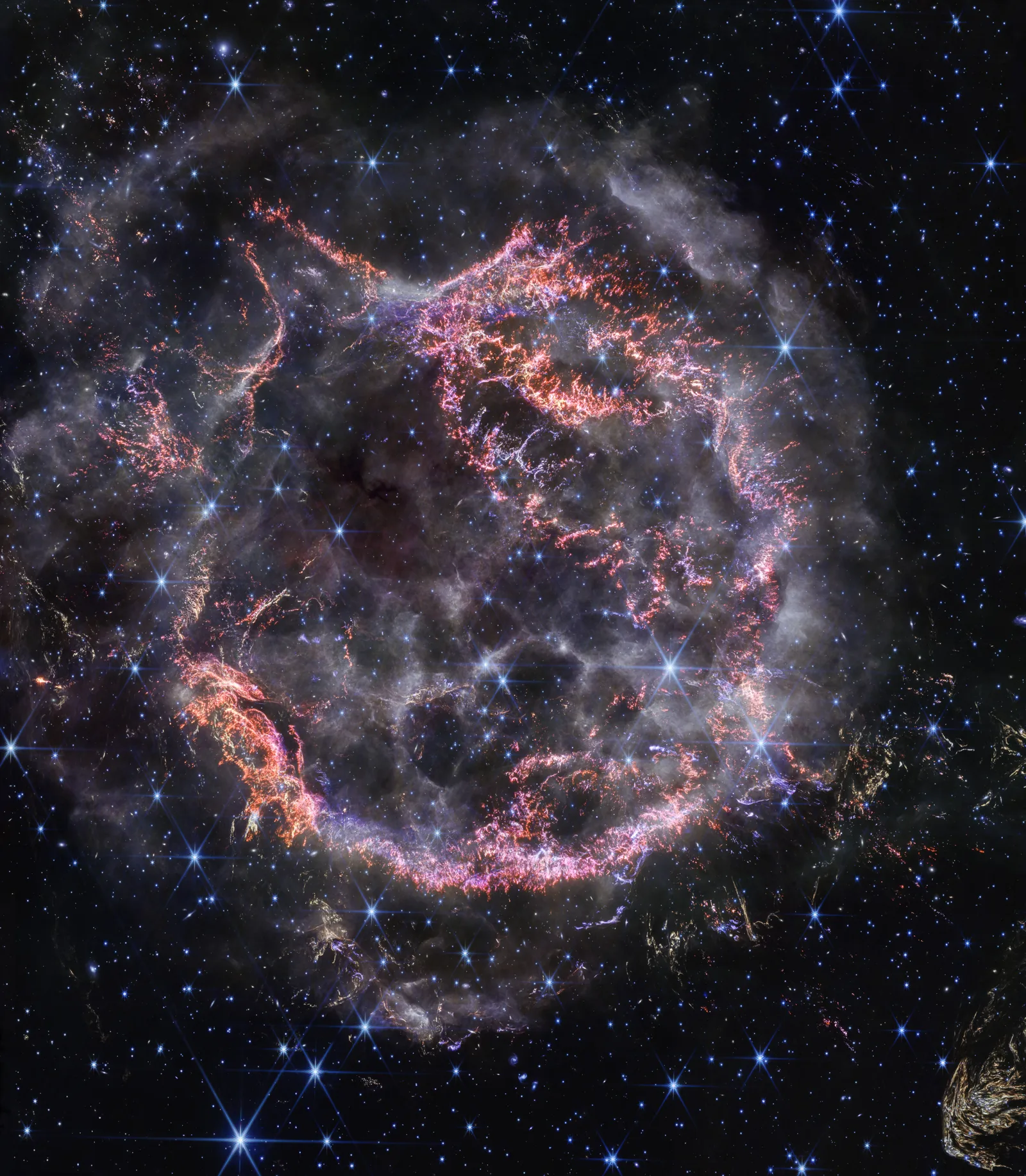 Cassiopeia A in infrared — Spitzer MIPS 24 μm imaging reveals vast light echo sheets caused by the supernova flash still heating circumstellar dust hundreds of light-years from the remnant.