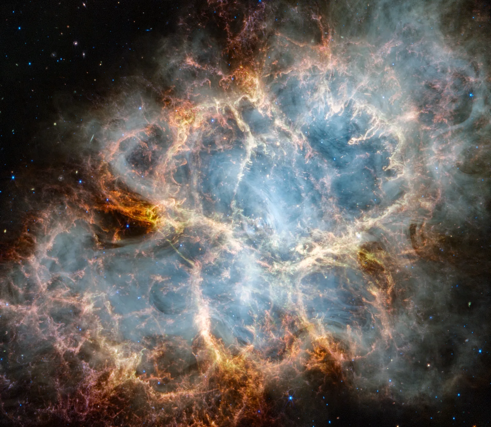 Crab Nebula in infrared — Spitzer IRAC reveals warm dust grains and synchrotron emission in the filaments, tracing the interface between the pulsar wind and shocked ejecta.