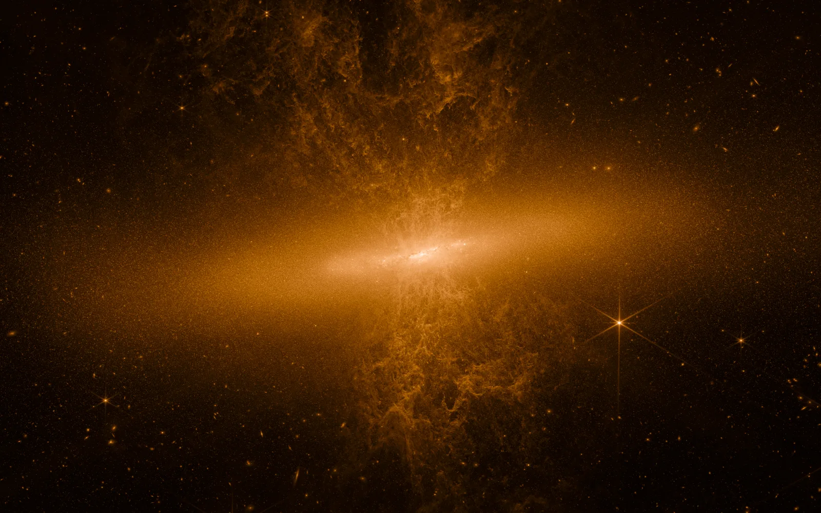 M82 (Cigar Galaxy) in infrared — JWST's near-infrared view resolves millions of stars in M82's blazing disk and traces the bipolar superwind as glowing tendrils of warm dust erupting above and below the galaxy.